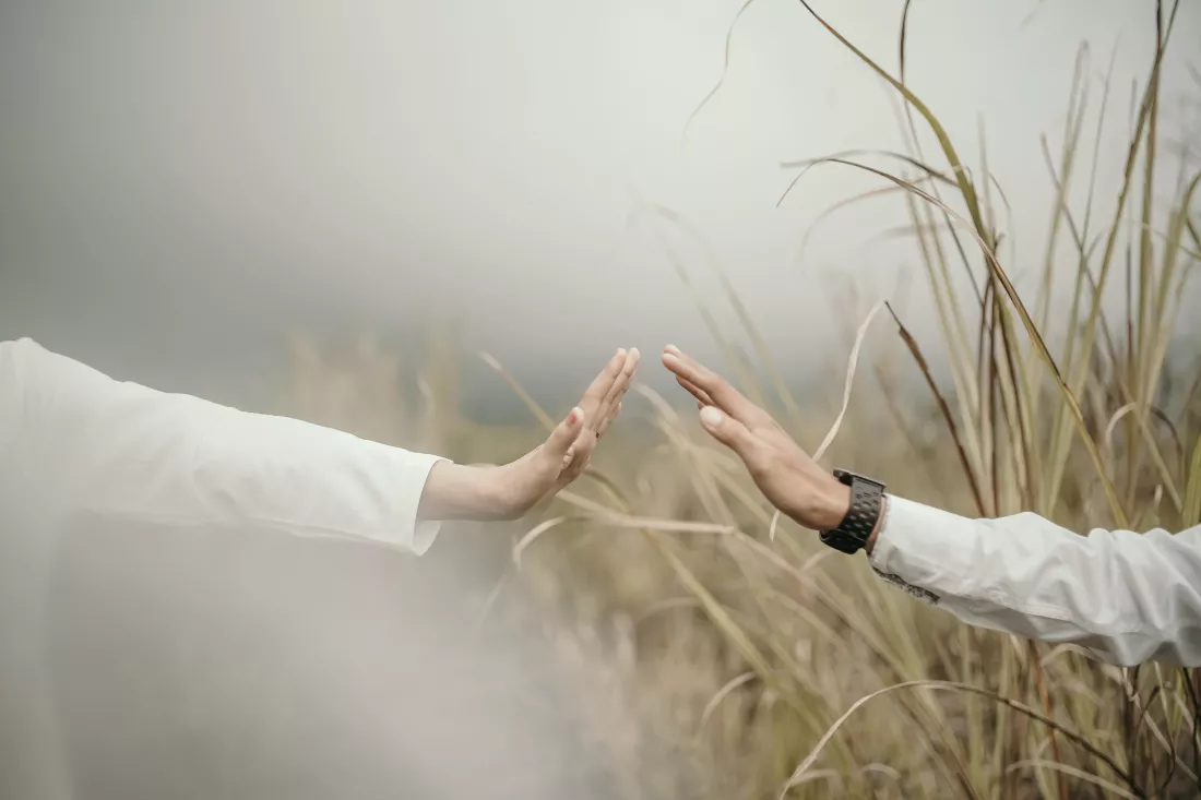 midsection-man-with-arms-raised-against-sky