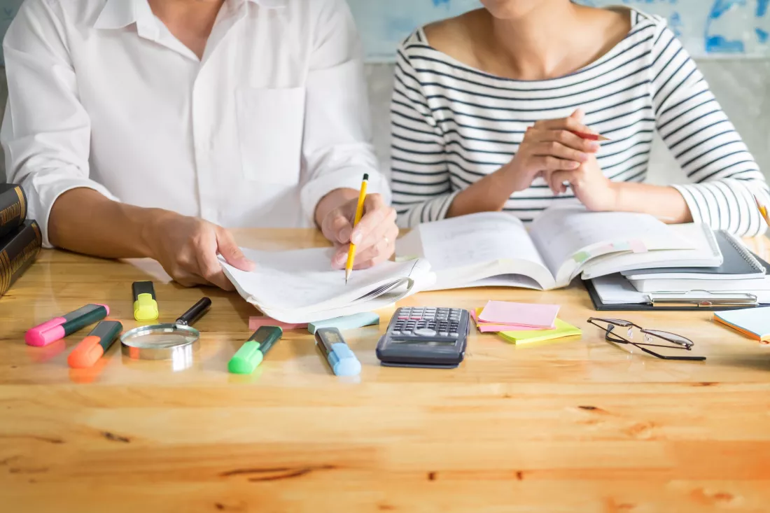 midsection-colleagues-doing-paperwork-office