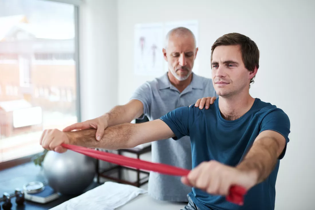 physical-resistance-band-strength-training-with-man-physiotherapist-office-appointment-exercise-fitness-recovery-professional-with-physiotherapy-patient-rehabilitation-clinic