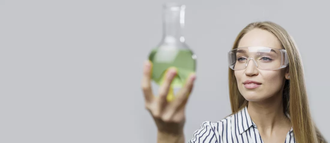 front-view-female-scientist-holding-test-tube-with-copy-space