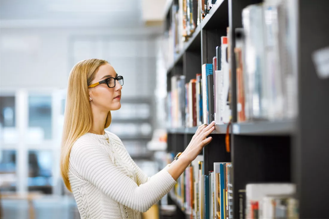 girl-glasses-book-shelf-library-reading-learning-education-with-university-student-check-search-with-research-knowledge-resources-study-college-scholarship